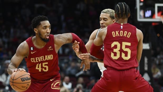 Feb 13, 2023; Cleveland, Ohio, USA; Cleveland Cavaliers guard Donovan Mitchell (45) drives to the basket as forward Isaac Okoro (35) sets a pick on San Antonio Spurs forward Jeremy Sochan (10) during the second half at Rocket Mortgage FieldHouse. Mandatory Credit: Ken Blaze-USA TODAY Sports